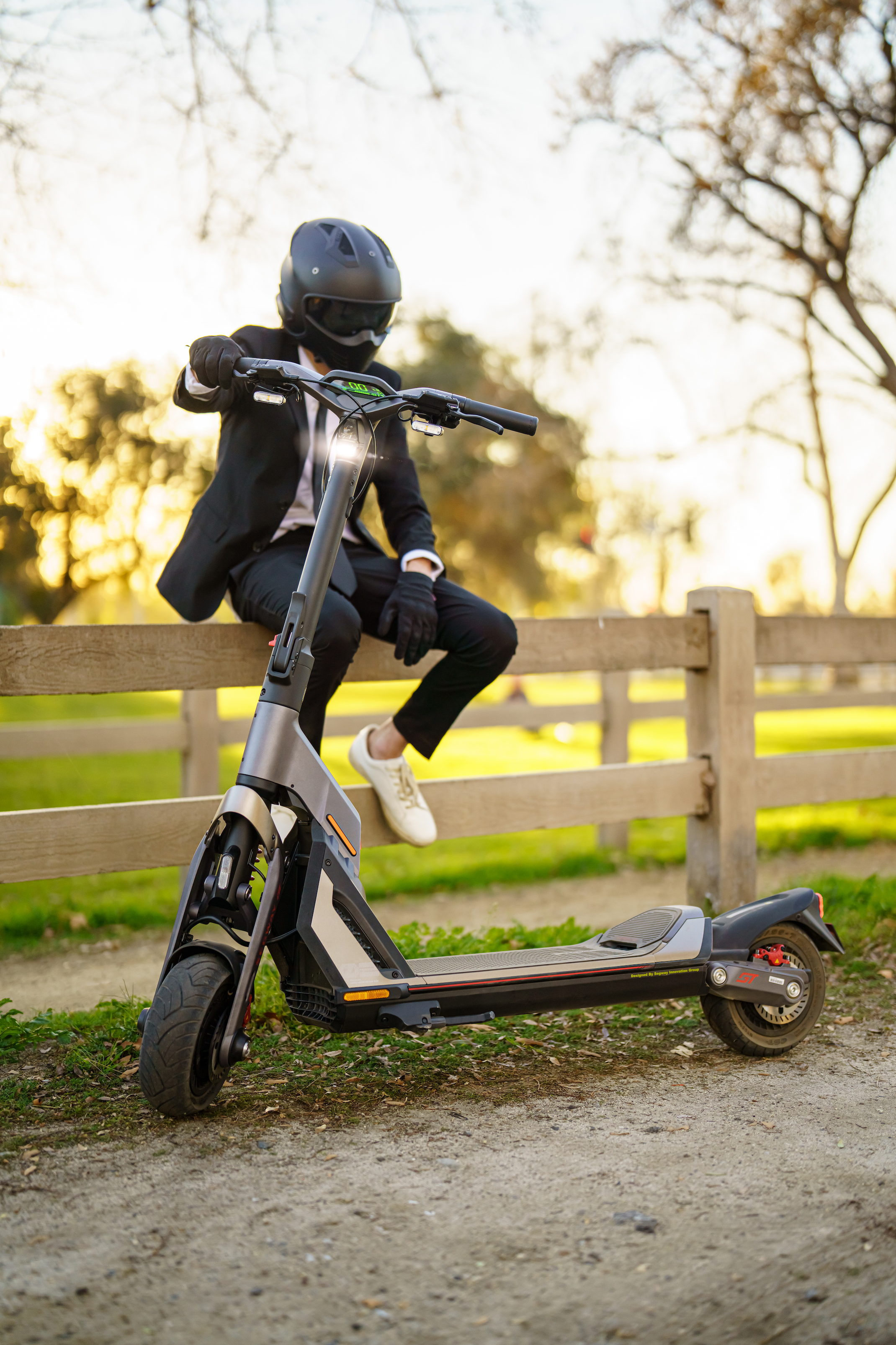 Segwayt KickScooter GT series_Lifestyle picture_Man sitting KickScooter standing_Vertical